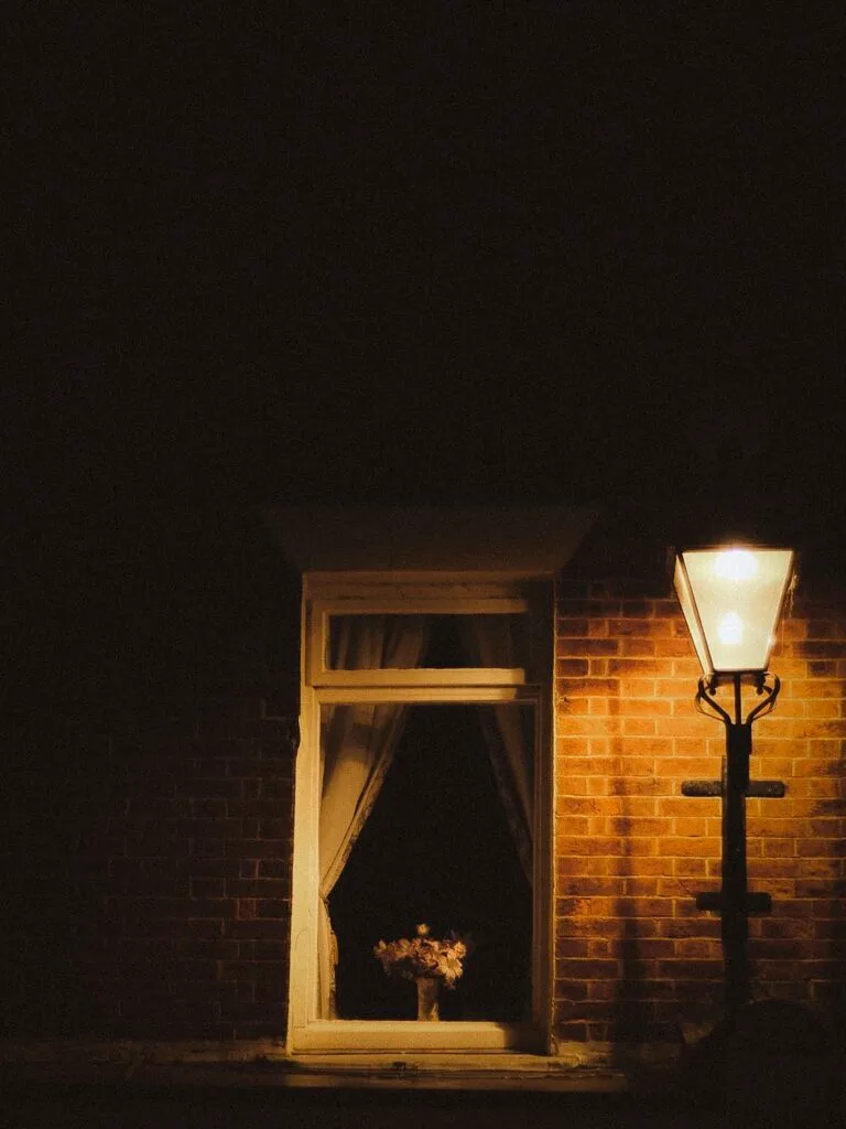 Emsworth high street at night with glowing shopfronts