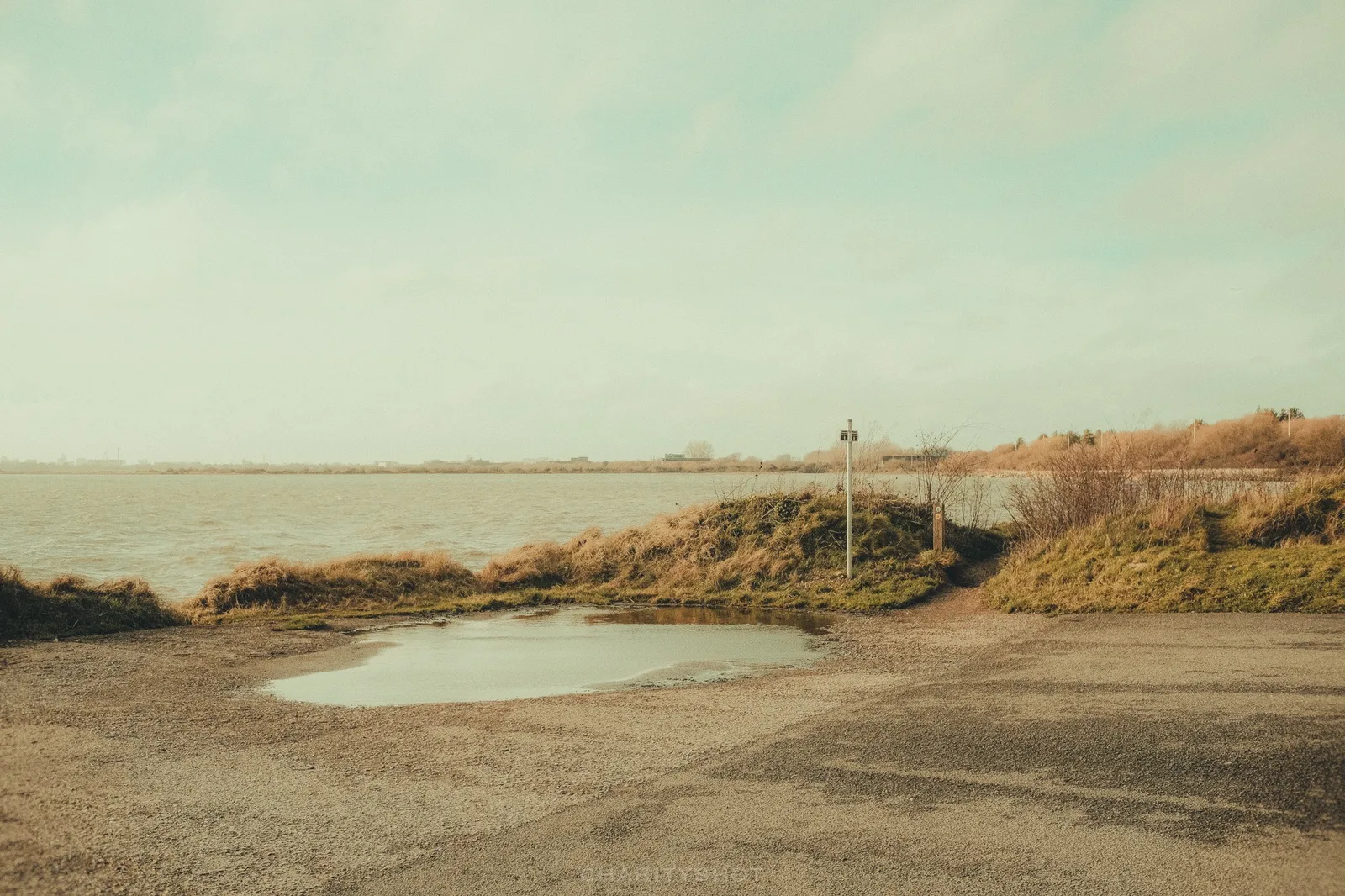 Fishermen along Broadmarsh sea wall in windy conditions