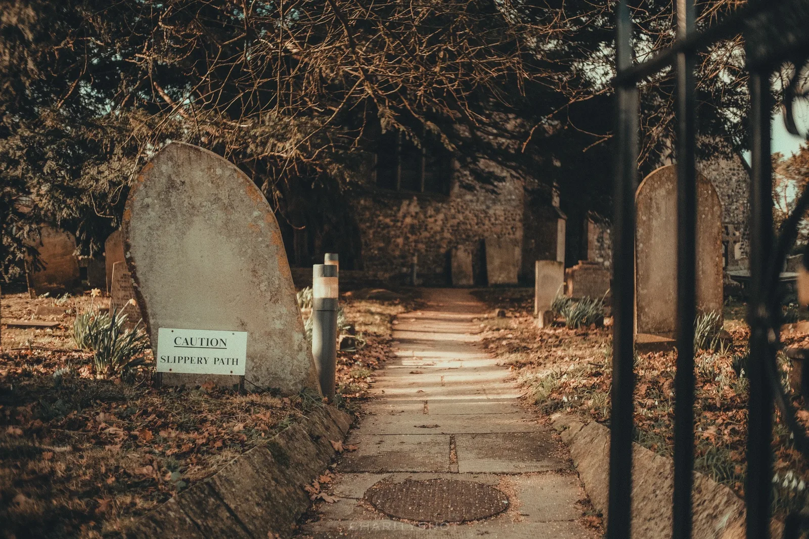 Slippery Surface warning sign in Bidbury church graveyard
