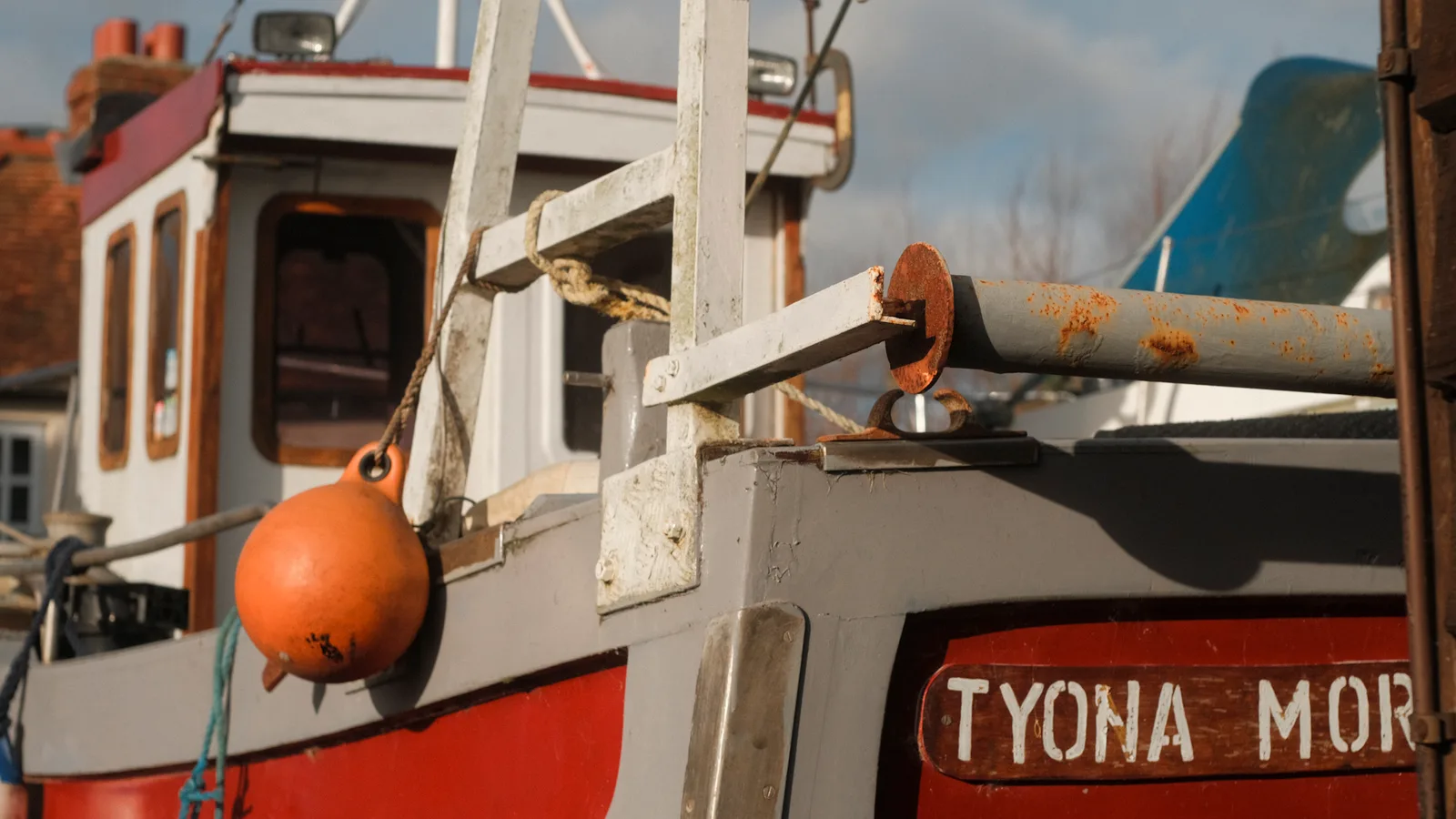Weathered fishing boat detail with orange buoy at Emsworth Harbour