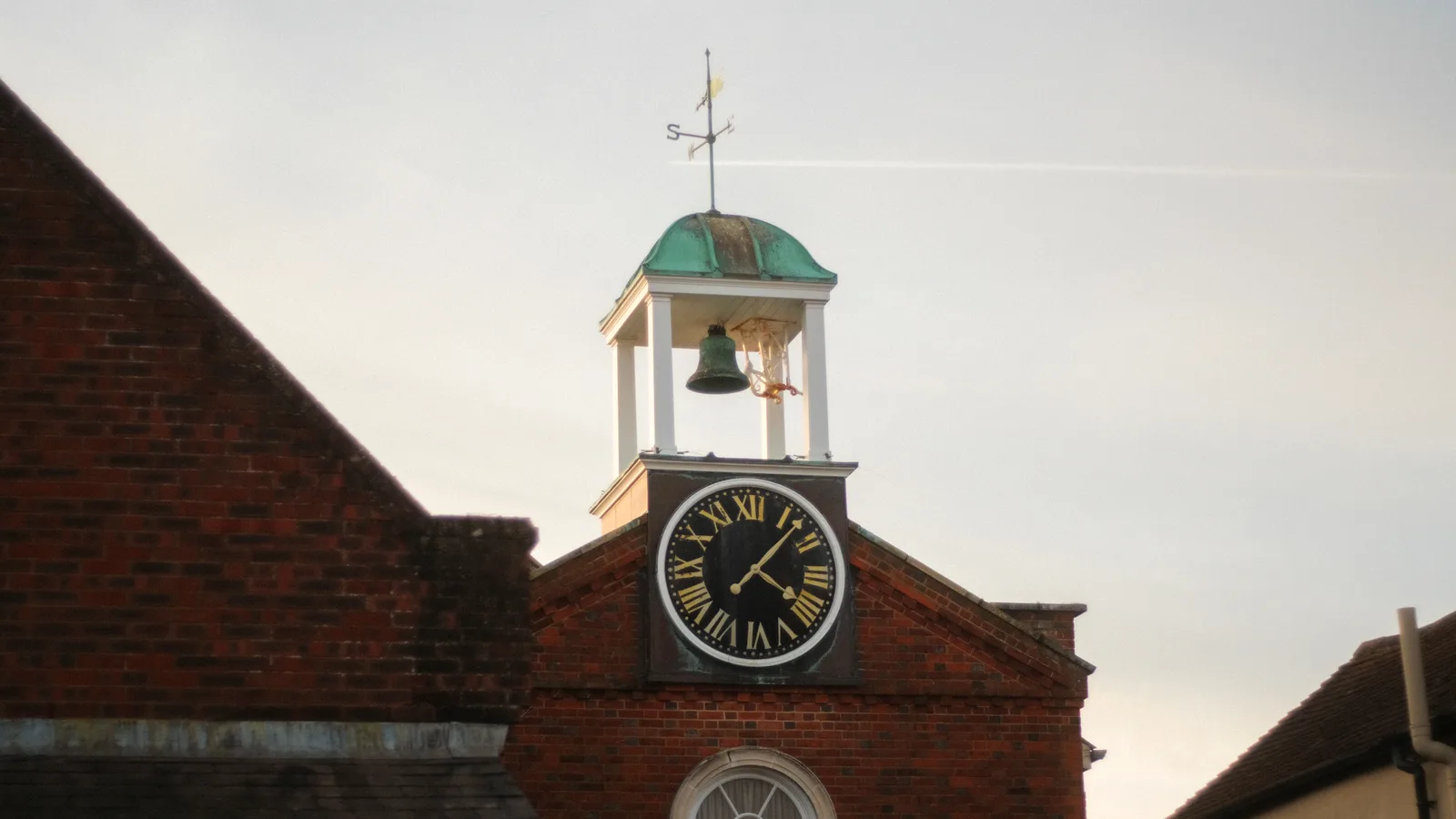 Historic clock tower with weathervane in Emsworth